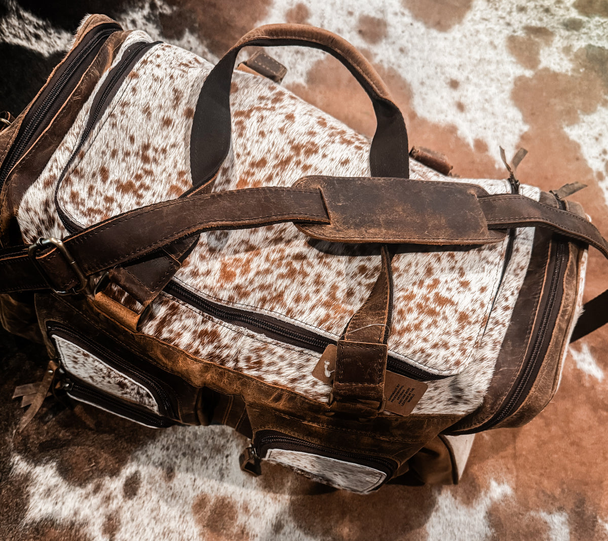 Cowhide & tan leather duffle bag