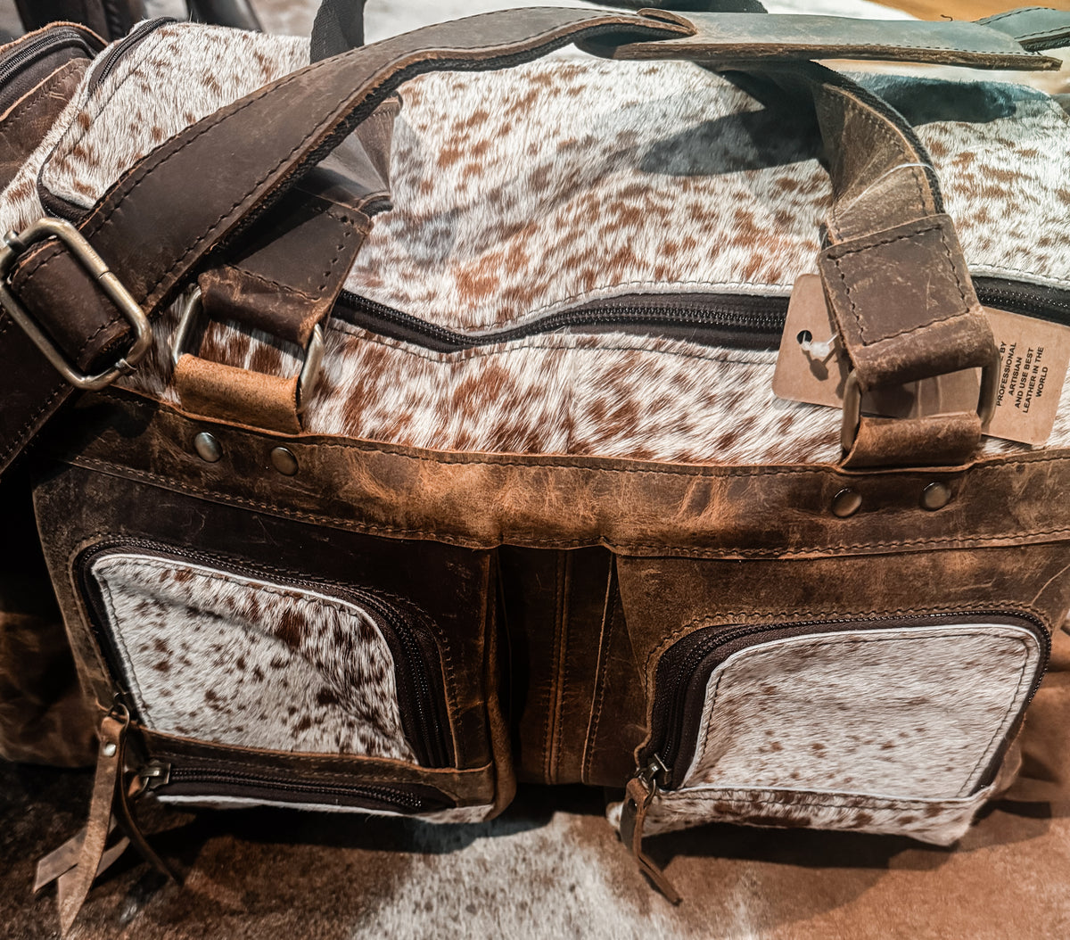 Cowhide & tan leather duffle bag