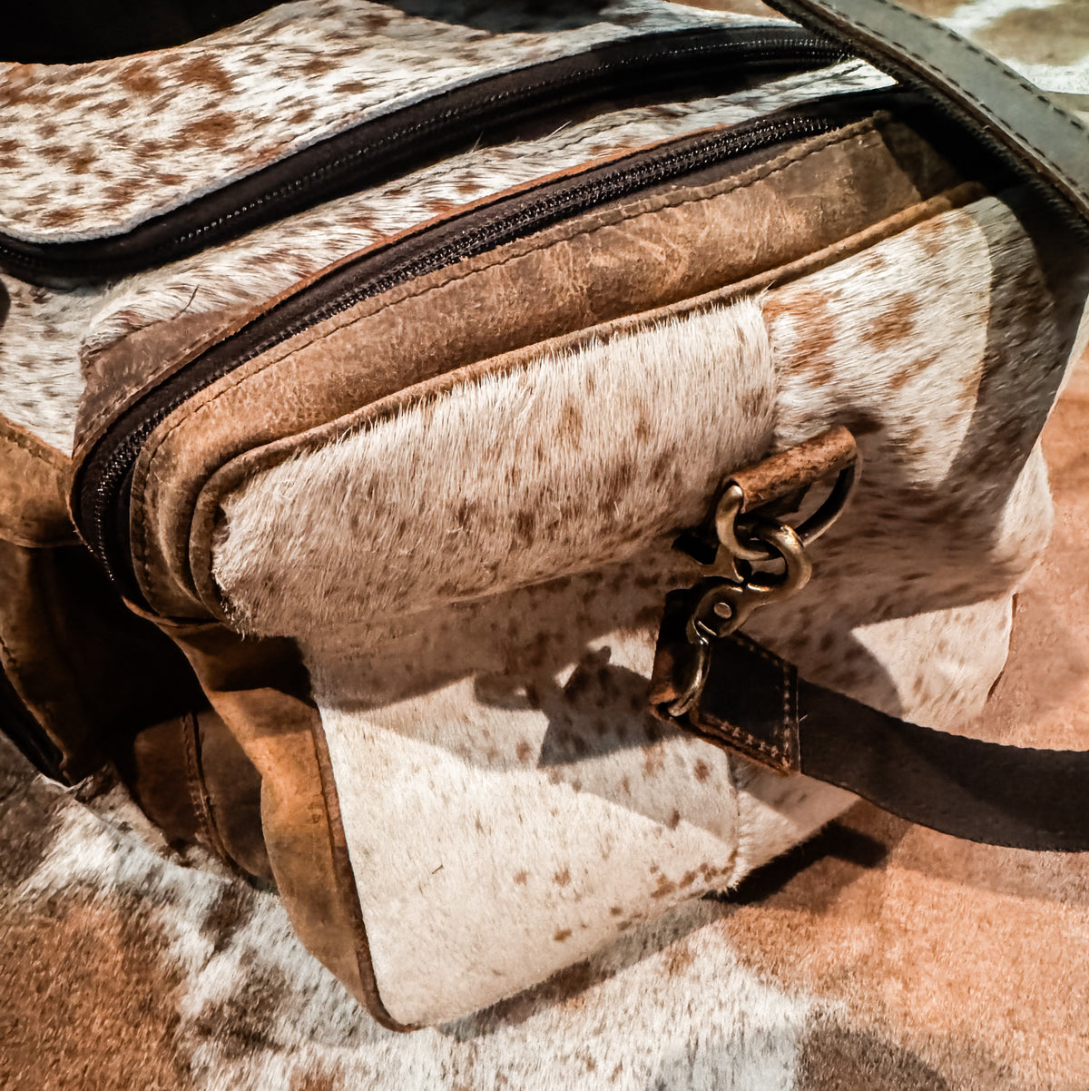 Cowhide & tan leather duffle bag