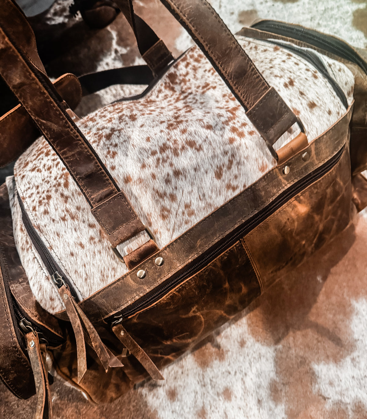 Cowhide & tan leather duffle bag