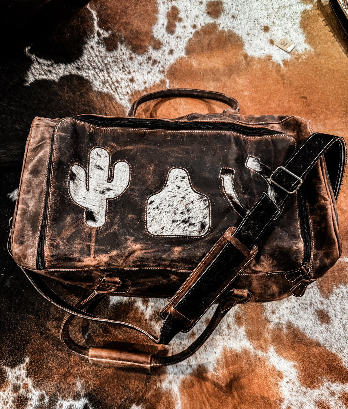 Cactus, cow tag, & horseshoe cowhide and leather duffel bag