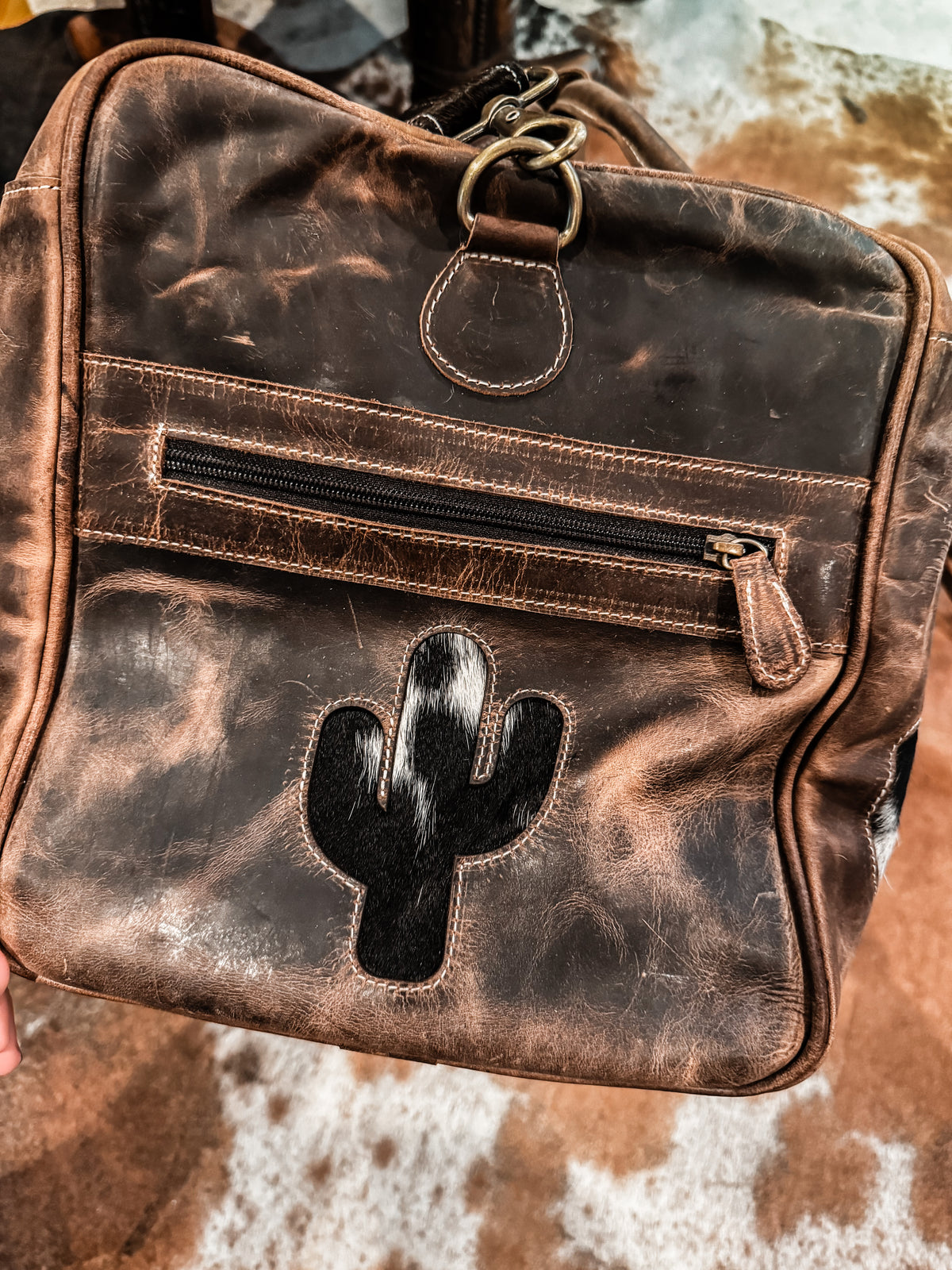 Cactus, cow tag, & horseshoe cowhide and leather duffel bag